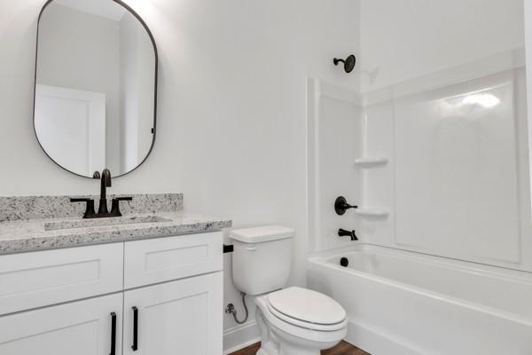 191 Charleston Ave, Pleasant View, TN 37146 - full bathroom with vanity, bathing tub / shower combination, and wood finished floors