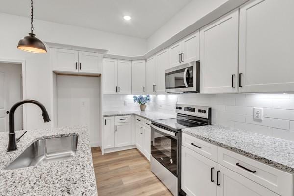 199 Charleston Ave, Pleasant View, TN 37146 - kitchen featuring appliances with stainless steel finishes, white cabinetry, hanging light fixtures, backsplash, and recessed lighting