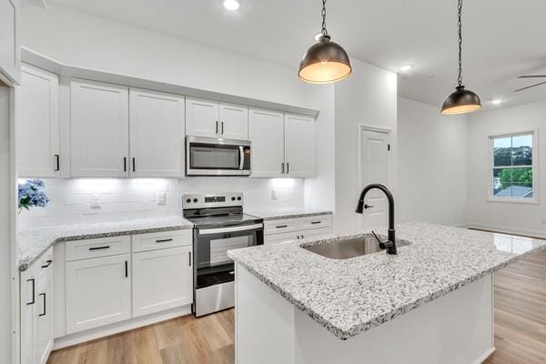 199 Charleston Ave, Pleasant View, TN 37146 - kitchen featuring stainless steel appliances, light wood-style flooring, pendant lighting, white cabinets, and recessed lighting
