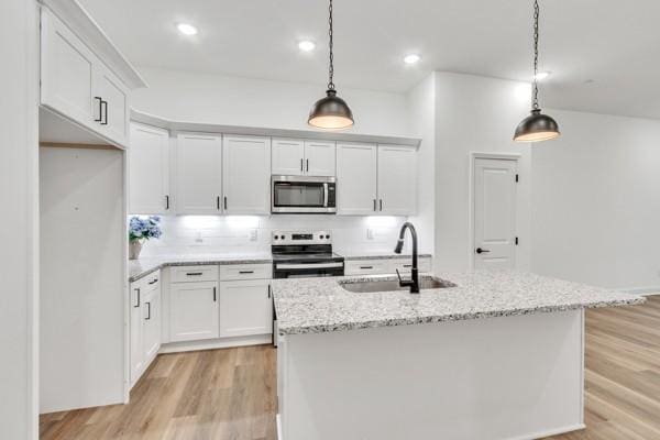 199 Charleston Ave, Pleasant View, TN 37146 - kitchen with appliances with stainless steel finishes, light wood-style flooring, white cabinets, pendant lighting, and recessed lighting