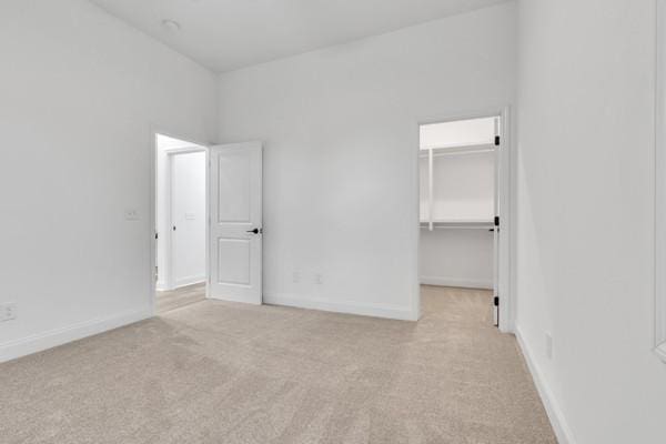 199 Charleston Ave, Pleasant View, TN 37146 - unfurnished bedroom with carpet, a walk in closet, and a closet