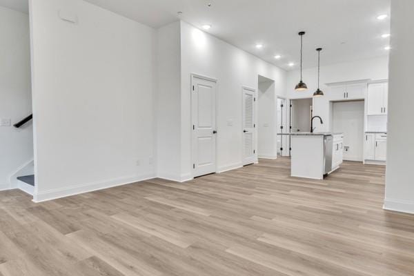 199 Charleston Ave, Pleasant View, TN 37146 - unfurnished living room with light wood-style flooring, recessed lighting, and stairway