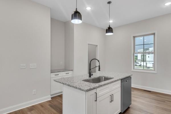203 Charleston Ave, Pleasant View, TN 37146 - kitchen featuring dishwasher, wood finished floors, white cabinets, light stone counters, and hanging light fixtures