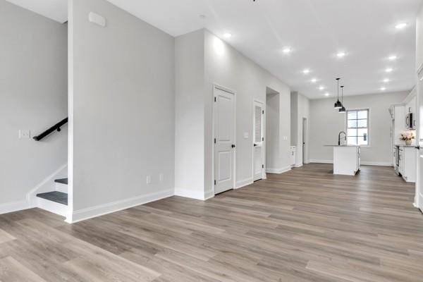 203 Charleston Ave, Pleasant View, TN 37146 - unfurnished living room with wood finished floors, recessed lighting, and stairway