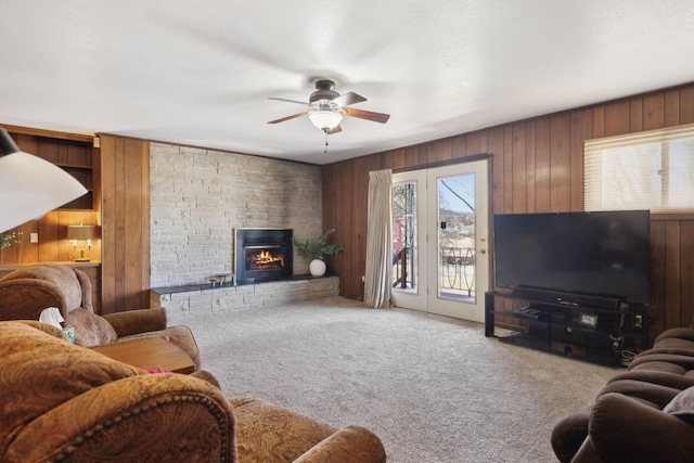 305 Myers Ter, Carthage, TN 37030 - living area with carpet floors, a ceiling fan, wooden walls, and a large fireplace