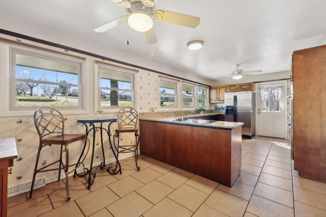 305 Myers Ter, Carthage, TN 37030 - kitchen with stainless steel fridge with ice dispenser, a peninsula, a ceiling fan, brown cabinets, and light tile patterned floors