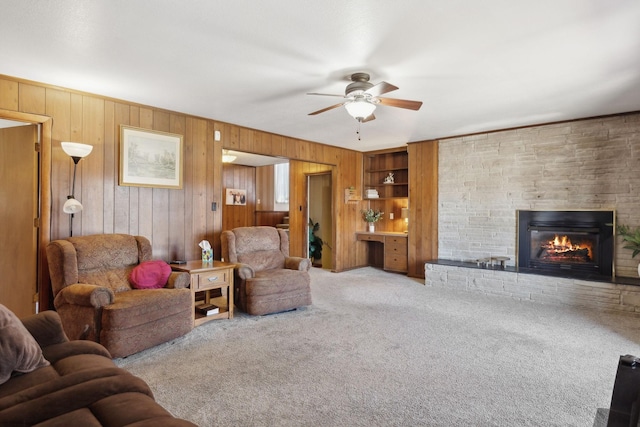305 Myers Ter, Carthage, TN 37030 - living room with ceiling fan, carpet flooring, wood walls, and a brick fireplace