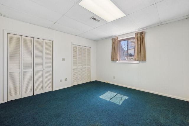305 Myers Ter, Carthage, TN 37030 - unfurnished bedroom featuring a drop ceiling, dark carpet, and multiple closets