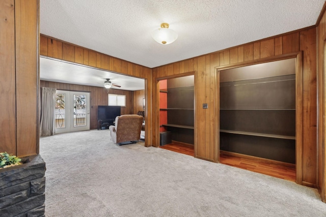 305 Myers Ter, Carthage, TN 37030 - unfurnished living room featuring carpet flooring, wood walls, ceiling fan, and a textured ceiling