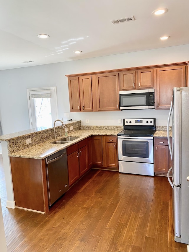 1808 Luke Ct, Columbia, TN 38401 - kitchen featuring stainless steel appliances, a peninsula, dark wood-type flooring, light stone countertops, and recessed lighting