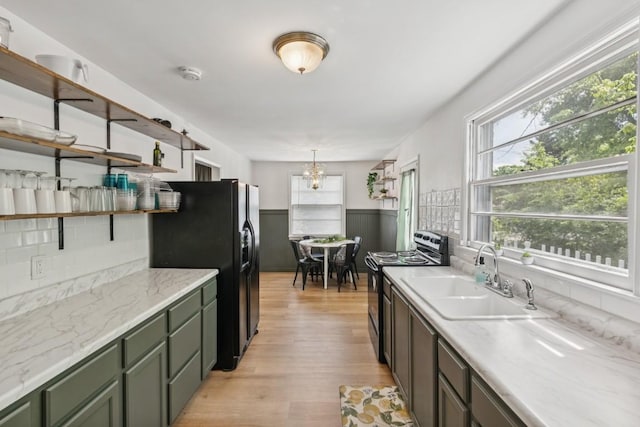 3721 Wharton Dr, Nashville, TN 37211 - kitchen featuring black appliances, open shelves, healthy amount of natural light, green cabinetry, and a wainscoted wall