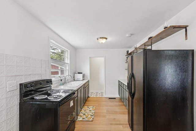 3721 Wharton Dr, Nashville, TN 37211 - kitchen with black appliances, light wood-style floors, light countertops, and backsplash