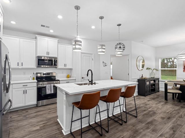 345 Winston Way, Gallatin, TN 37066 - kitchen with appliances with stainless steel finishes, white cabinets, dark wood finished floors, recessed lighting, and a center island with sink
