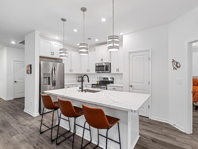 345 Winston Way, Gallatin, TN 37066 - kitchen with stainless steel appliances, dark wood finished floors, recessed lighting, a kitchen island with sink, and a breakfast bar