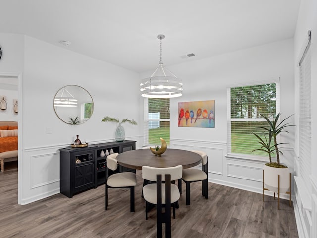 345 Winston Way, Gallatin, TN 37066 - dining area featuring a chandelier, dark wood-type flooring, a decorative wall, plenty of natural light, and wainscoting