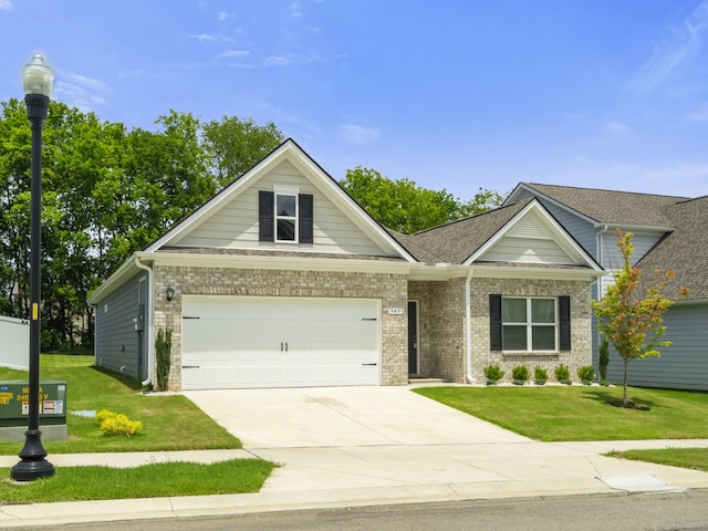 345 Winston Way, Gallatin, TN 37066 - view of front of property with a front lawn, brick siding, driveway, an attached garage, and a shingled roof