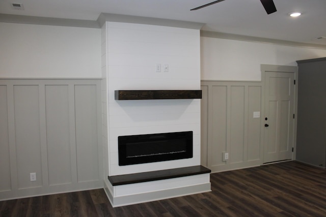 807 Hasty Ln, Estill Springs, TN 37330 - unfurnished living room featuring a decorative wall, dark wood-style floors, a wainscoted wall, ceiling fan, and a large fireplace