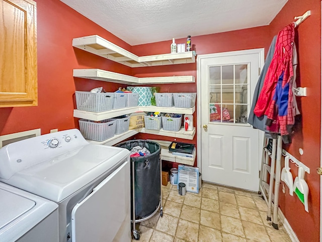 1097 Taylor Ln, Newbern, TN 38059 - laundry area featuring washing machine and dryer, cabinet space, stone tile floors, and a textured ceiling