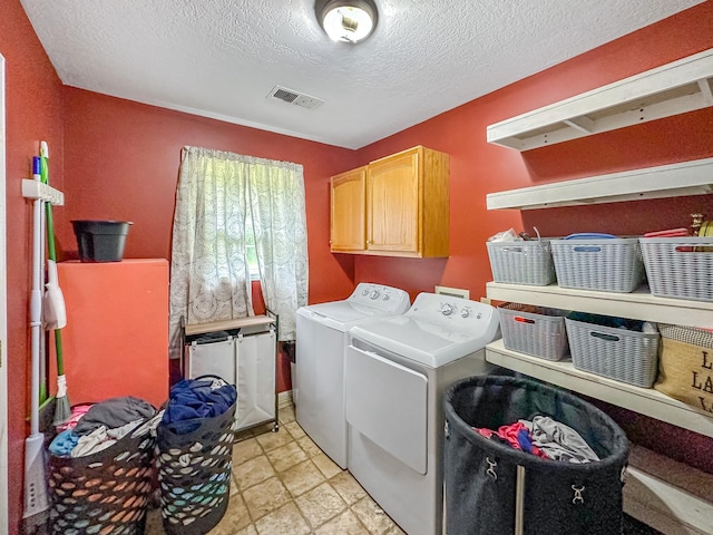 1097 Taylor Ln, Newbern, TN 38059 - laundry room featuring cabinet space, washing machine and clothes dryer, and a textured ceiling