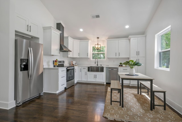 704 Pond Rd, Dickson, TN 37055 - kitchen featuring appliances with stainless steel finishes, wall chimney range hood, plenty of natural light, white cabinetry, and recessed lighting