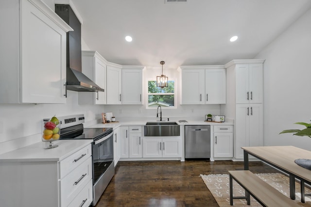 704 Pond Rd, Dickson, TN 37055 - kitchen featuring appliances with stainless steel finishes, wall chimney exhaust hood, light countertops, white cabinetry, and recessed lighting