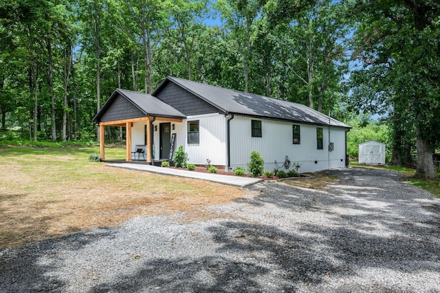 704 Pond Rd, Dickson, TN 37055 - modern farmhouse style home featuring a storage shed, a porch, driveway, and a metal roof