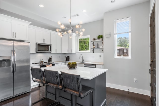 2410 Meharry Blvd Unit 3, Nashville, TN 37208 - kitchen with appliances with stainless steel finishes, a chandelier, tasteful backsplash, white cabinets, and recessed lighting