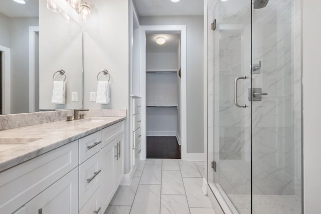 2410 Meharry Blvd Unit 3, Nashville, TN 37208 - bathroom featuring a marble finish shower, double vanity, a spacious closet, marble look tiles, and recessed lighting