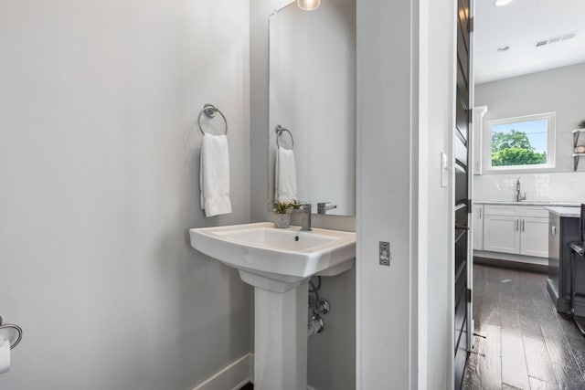 2410 Meharry Blvd Unit 3, Nashville, TN 37208 - bathroom featuring decorative backsplash and wood finished floors