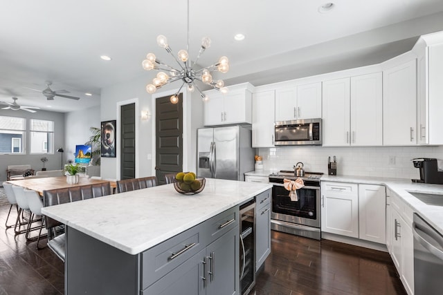 2410 Meharry Blvd Unit 3, Nashville, TN 37208 - kitchen with appliances with stainless steel finishes, wine cooler, white cabinets, backsplash, and recessed lighting