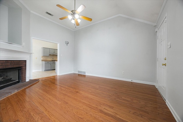 1117 Cross Wood Ln, Cordova, TN 38018 - unfurnished living room with lofted ceiling, a ceiling fan, wood finished floors, a fireplace, and ornamental molding