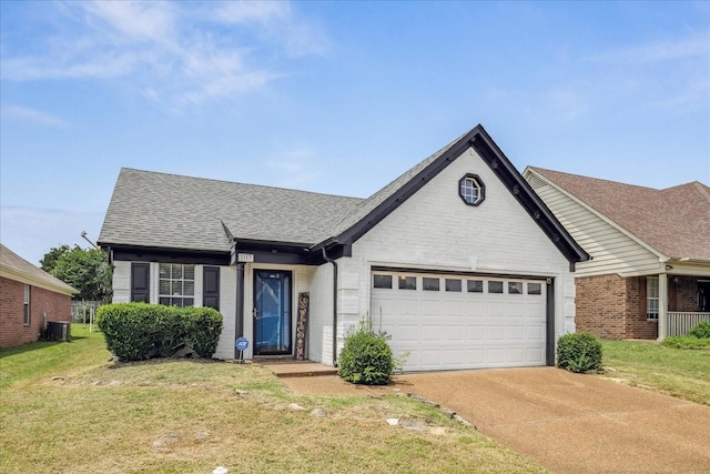 1117 Cross Wood Ln, Cordova, TN 38018 - view of front of home featuring an attached garage, concrete driveway, brick siding, a front lawn, and roof with shingles