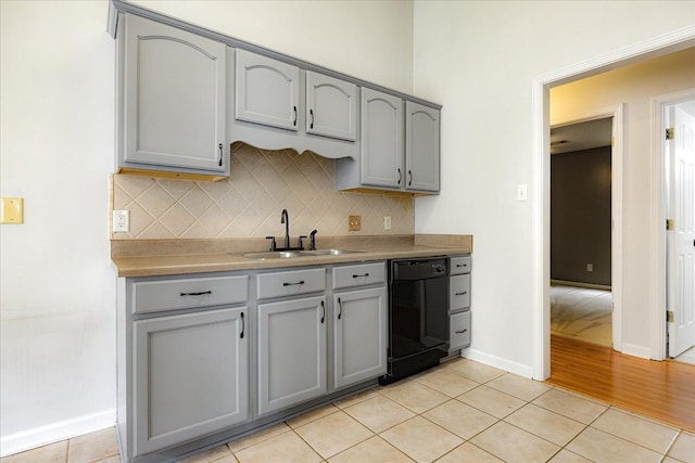 1117 Cross Wood Ln, Cordova, TN 38018 - kitchen with gray cabinetry, black dishwasher, light tile patterned floors, and decorative backsplash