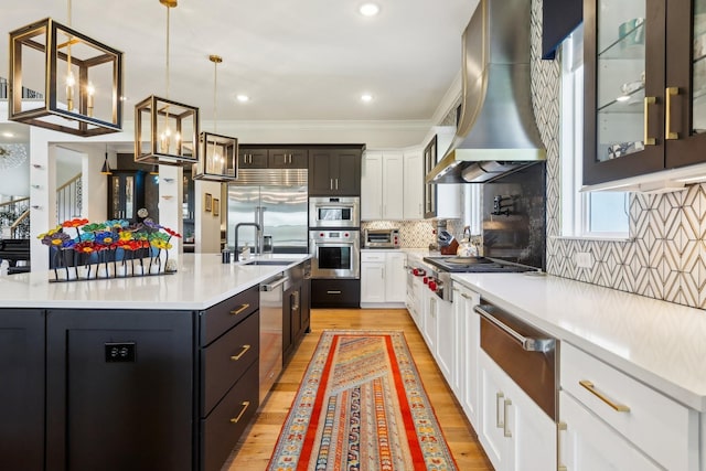 6004 Lookaway Cir, Franklin, TN 37067 - kitchen featuring stainless steel appliances, a warming drawer, range hood, light wood finished floors, and light countertops