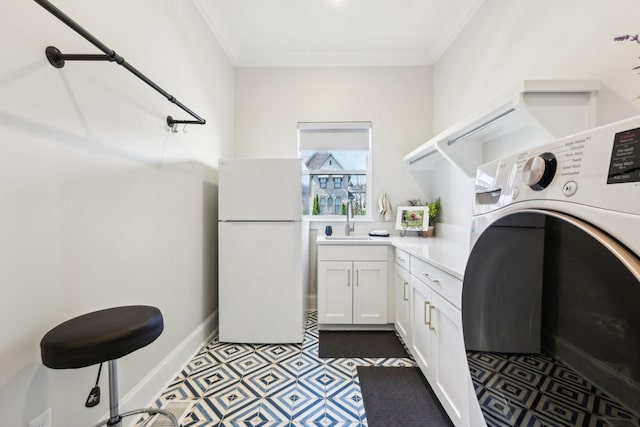 6004 Lookaway Cir, Franklin, TN 37067 - laundry area with washer / clothes dryer, ornamental molding, cabinet space, and dark flooring