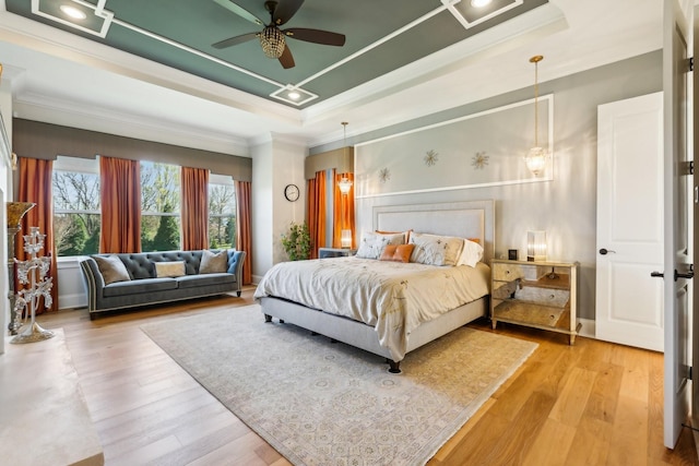 6004 Lookaway Cir, Franklin, TN 37067 - bedroom with crown molding, a raised ceiling, light wood-style floors, and ceiling fan