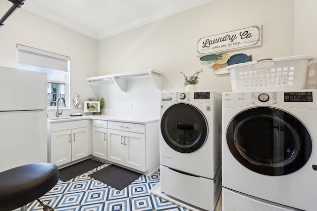 6004 Lookaway Cir, Franklin, TN 37067 - washroom with washer and clothes dryer, crown molding, and cabinet space