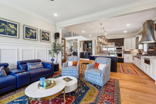 6004 Lookaway Cir, Franklin, TN 37067 - living area featuring ornamental molding, light wood-style flooring, recessed lighting, and a decorative wall