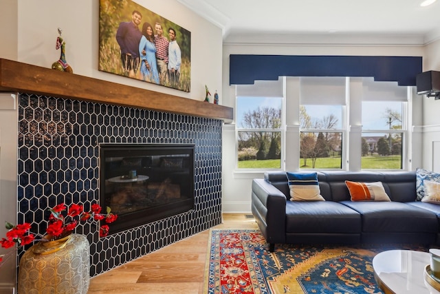 6004 Lookaway Cir, Franklin, TN 37067 - living room with a tile fireplace, wood finished floors, and crown molding