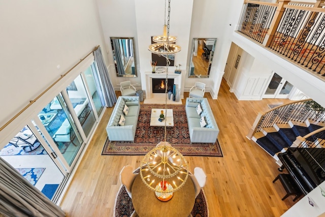 6004 Lookaway Cir, Franklin, TN 37067 - living room with a chandelier, a high ceiling, and wood finished floors
