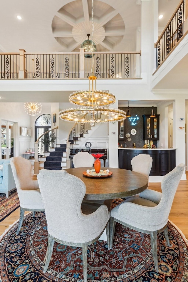 6004 Lookaway Cir, Franklin, TN 37067 - dining area with a chandelier, stairway, a towering ceiling, wood finished floors, and recessed lighting