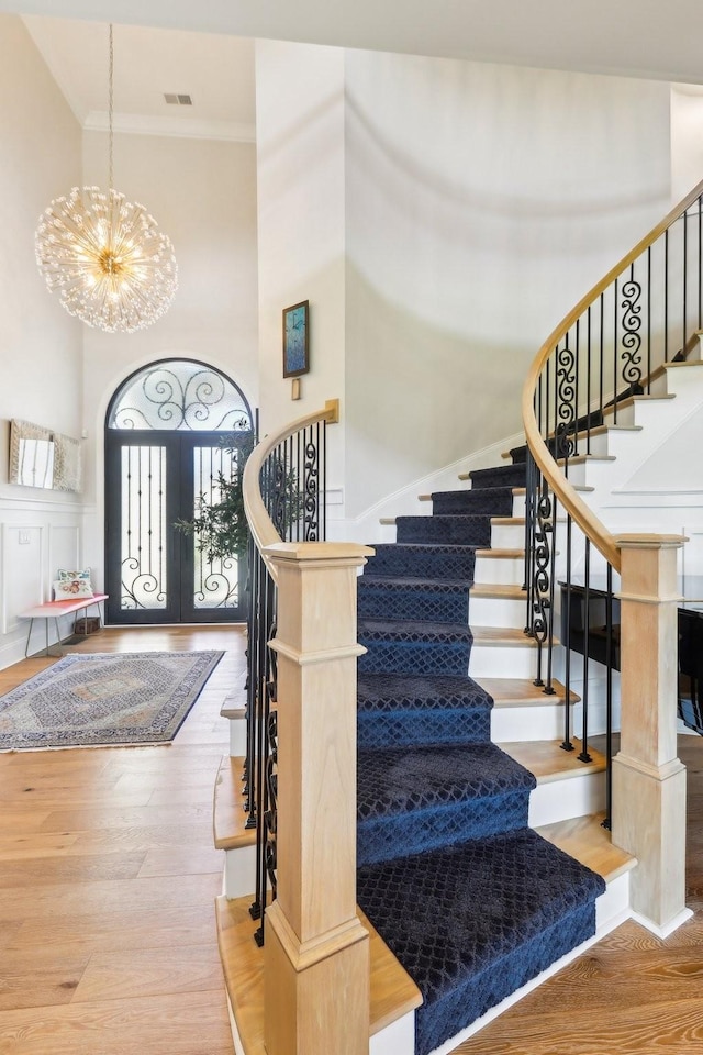 6004 Lookaway Cir, Franklin, TN 37067 - entryway with a chandelier, a towering ceiling, ornamental molding, wood finished floors, and stairway