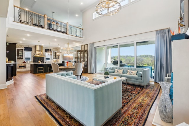 6004 Lookaway Cir, Franklin, TN 37067 - living area featuring a towering ceiling, light wood-type flooring, a chandelier, and recessed lighting