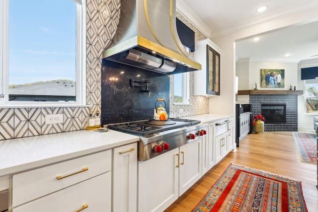 6004 Lookaway Cir, Franklin, TN 37067 - kitchen featuring stainless steel gas cooktop, island exhaust hood, crown molding, glass insert cabinets, and backsplash