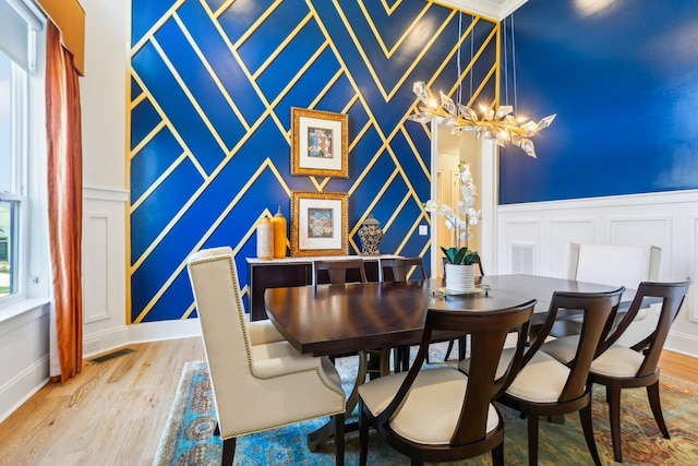 6004 Lookaway Cir, Franklin, TN 37067 - dining area featuring a decorative wall, wood finished floors, a chandelier, and an accent wall