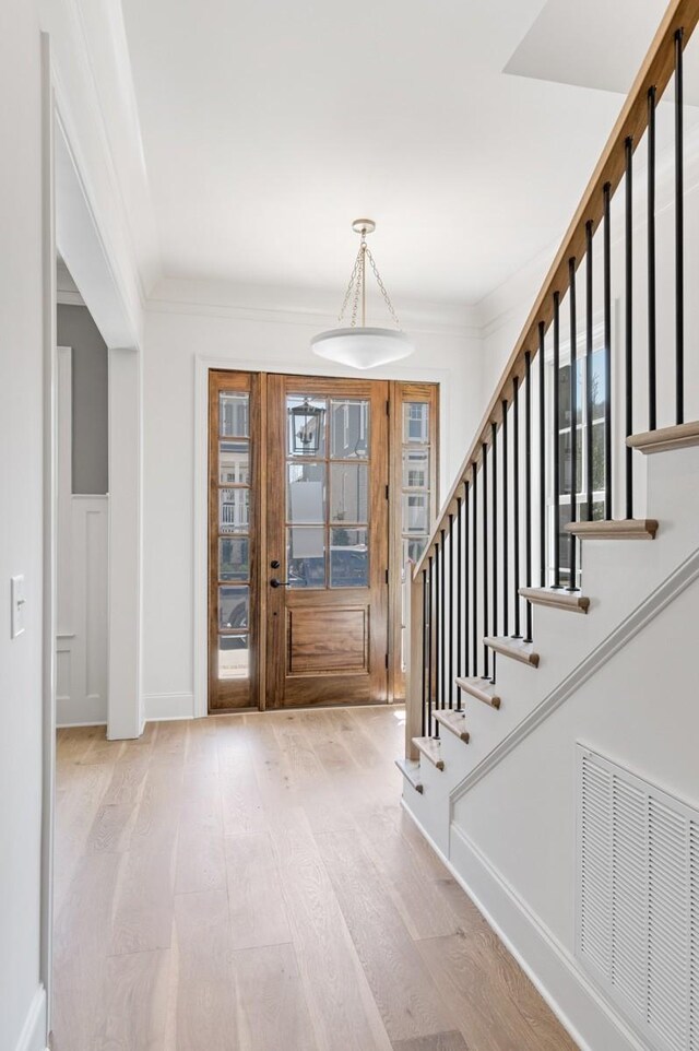 7018 Southvale Blvd, Franklin, TN 37064 - entryway featuring wood finished floors, stairs, and crown molding