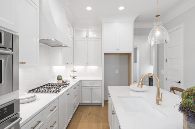 7018 Southvale Blvd, Franklin, TN 37064 - kitchen with stainless steel appliances, custom range hood, white cabinets, light wood-type flooring, and recessed lighting