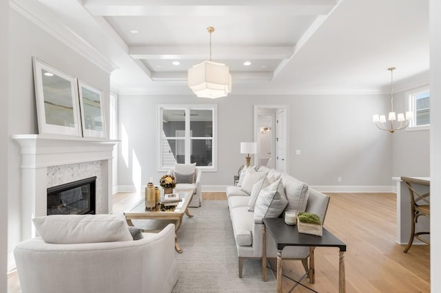 7018 Southvale Blvd, Franklin, TN 37064 - living room featuring a chandelier, ornamental molding, a premium fireplace, light wood-type flooring, and beamed ceiling