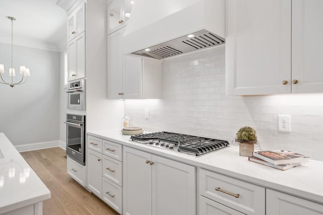 7018 Southvale Blvd, Franklin, TN 37064 - kitchen with stainless steel appliances, custom exhaust hood, white cabinetry, light countertops, and crown molding