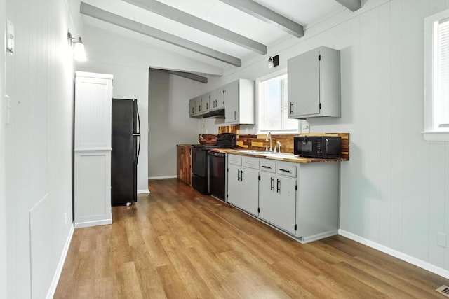 5011 Jarrett Rd, Chattanooga, TN 37416 - kitchen with black appliances, light wood-style floors, and under cabinet range hood
